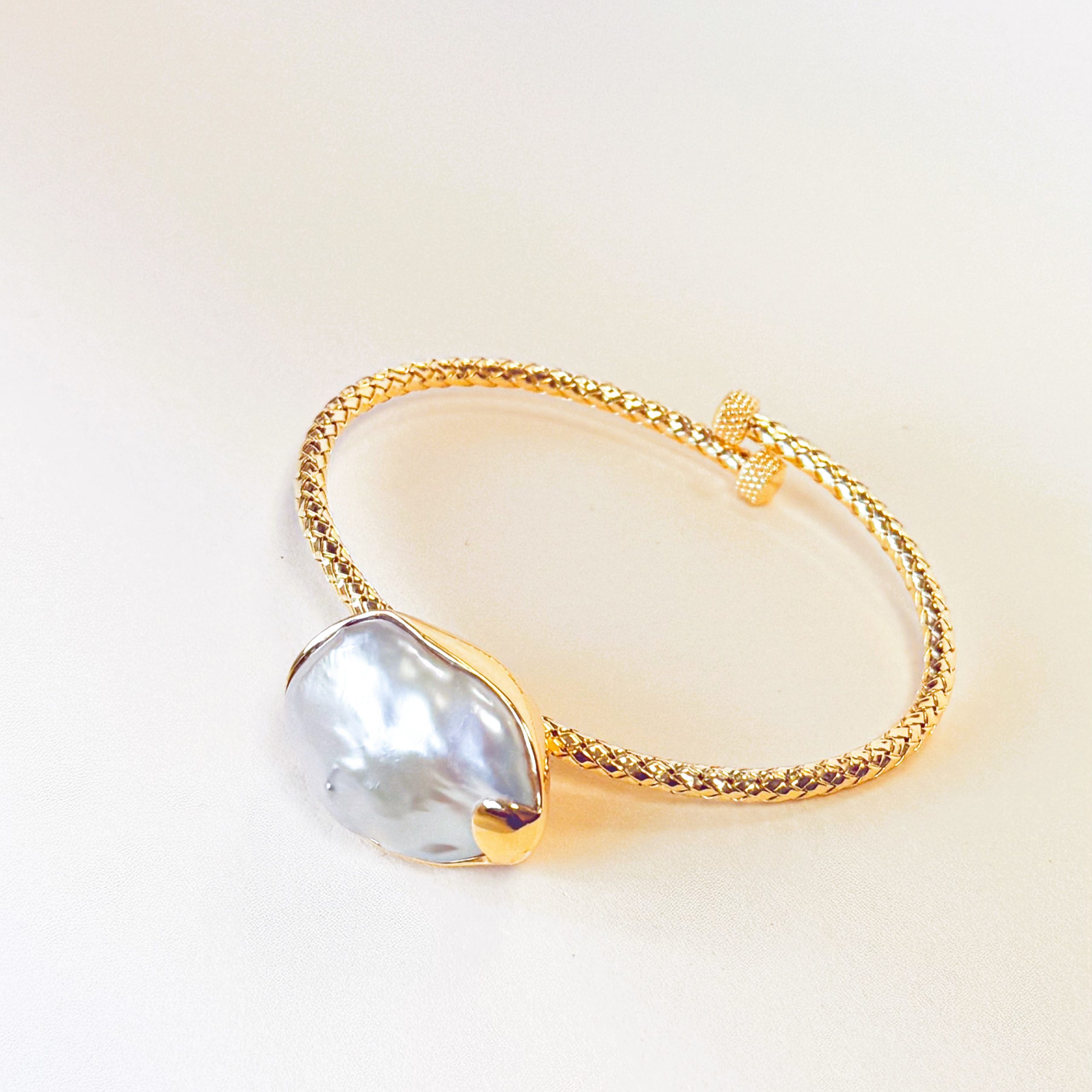 Baroque Pearl Vine Bangle in 18K Gold Vermeil featuring an intricate twisted vine design and a center Baroque freshwater pearl.